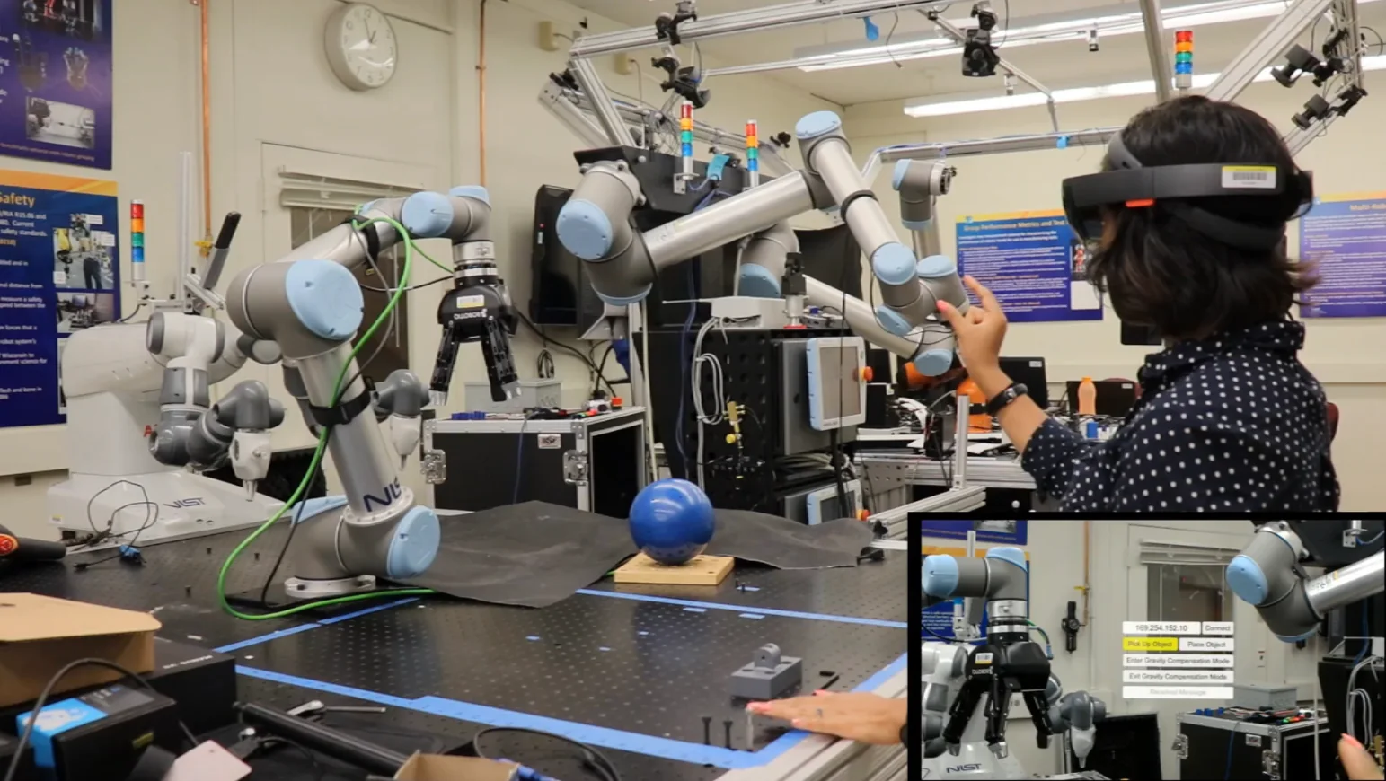 Researcher testing an augmented-reality interface for collaborative interaction with industrial robot arms at NIST.