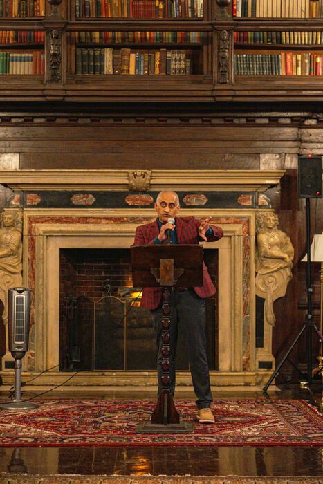 A speaker addresses guests from the lectern in the Library of the House of the Redeemer