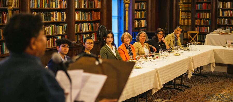 Guests seated at the long table during the inaugural HSI salon