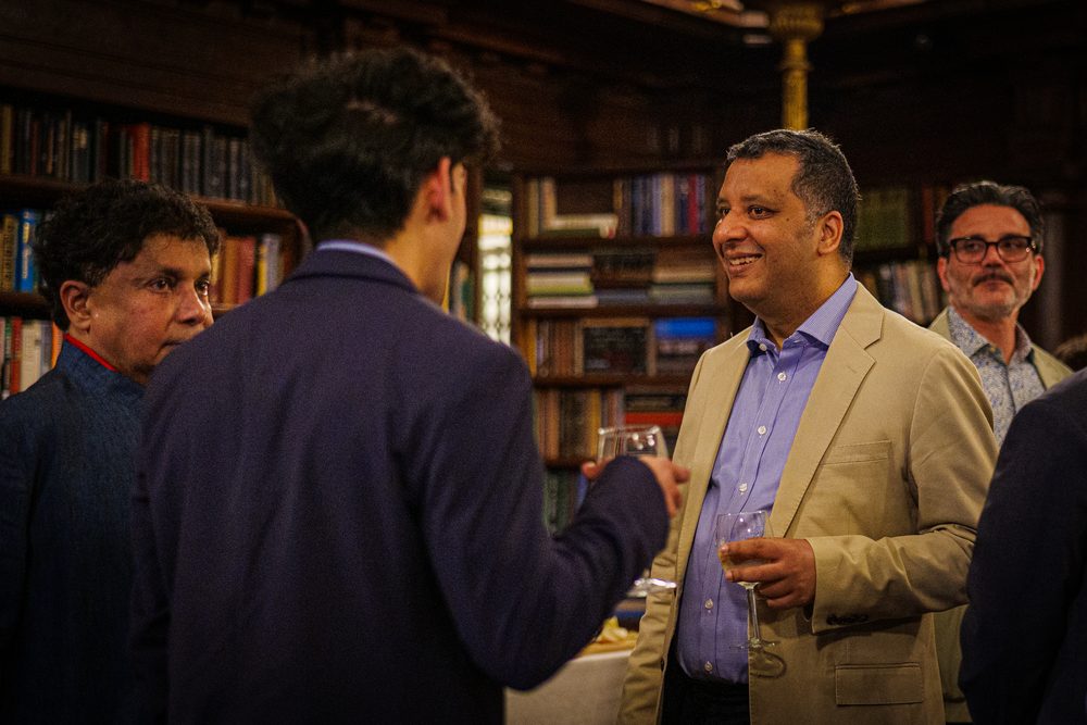 Guests in conversation in the Library before dinner